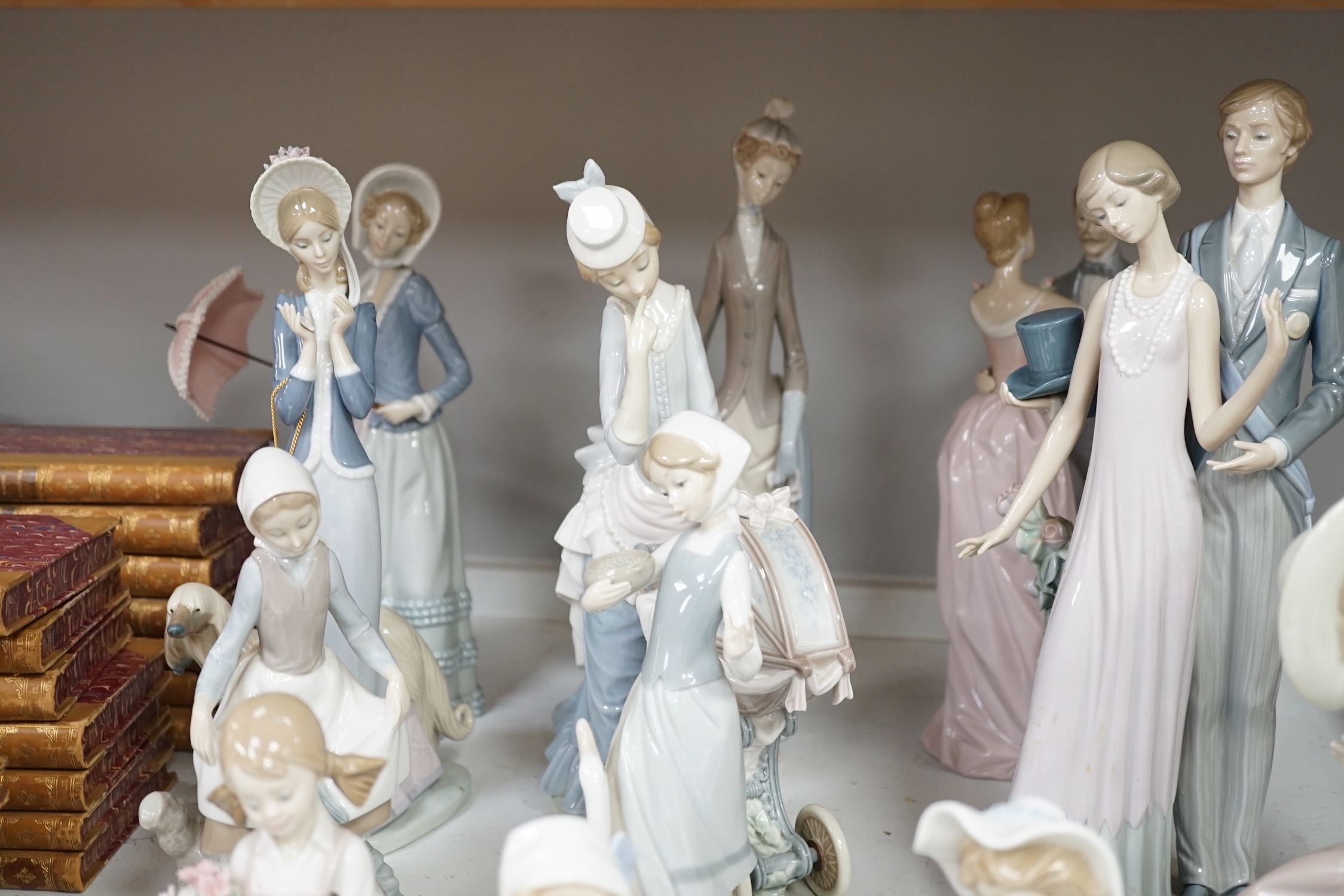 Collection of twelve Lladro figures including Precious Love and High Society